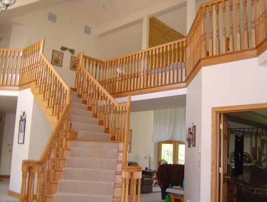 tan wood stairs with beige carpet